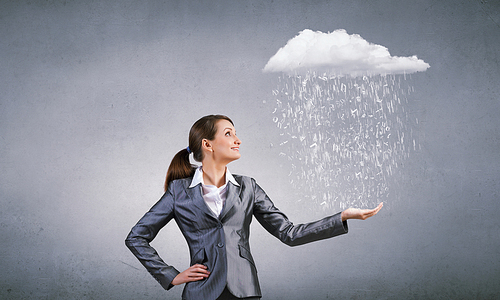 Young businesswoman holding white cloud in hands