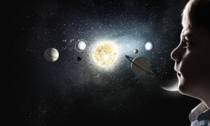 Cute boy of school age exploring space system