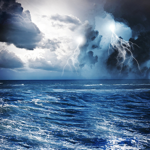 Image of dark night with lightning above stormy sea