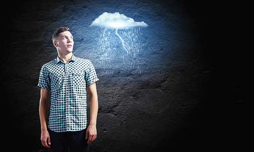 Young man looking at illustration of raining cloud