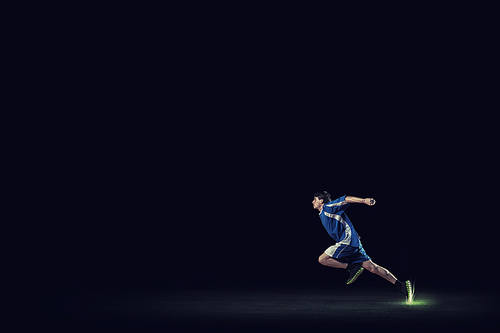 Running man in blue sport wear on black background