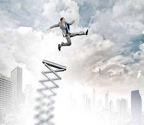 Businessman jumping on springboard as progress concept
