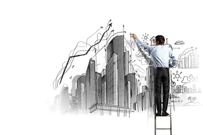 Back view of businessman drawing sketch on wall