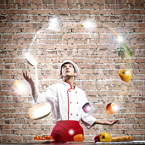 Young man at kitchen juggling with ingredients