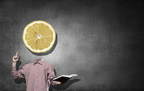 Headless man with book in hand anf lemon instead of head