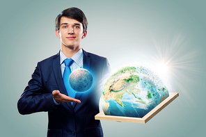 Handsome businessman holding frame with Earth planet. Elements of this image are furnished by NASA