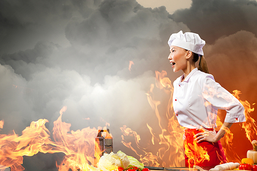 Asian female cook in anger against color background with shine effects