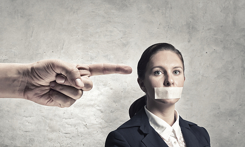 Young speechless businesswoman with adhesive tape on mouth