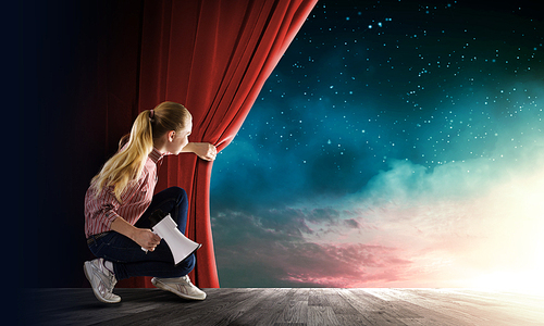 Young woman in casual with megaphone opening curtain