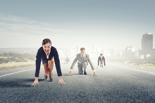 Business people on road in start position ready to run