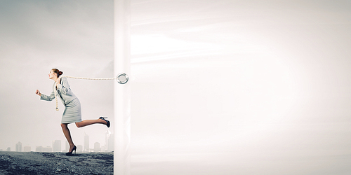 Young businesswoman running and pulling white blank banner