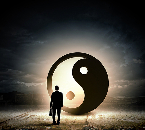 Rear view of businessman looking at yin yang sign