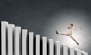 Young businessman running up on staircase representing success concept