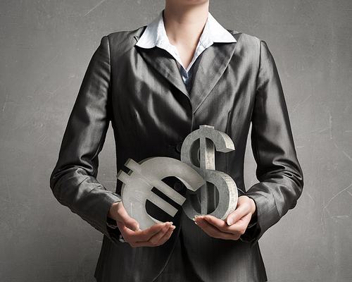 Close up of businesswoman holding dollar sign in hands