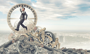 Young businessman in suit running in hamster wheel