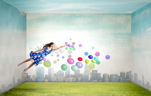 Young woman in summer dress flying in sky