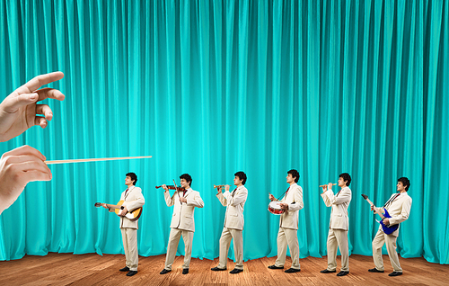 Man orchestra in suit playing different music instruments