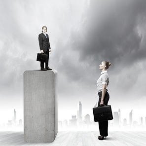Businessman standing on top and looking down at colleague