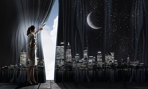 Young businesswoman opening stage curtain to another reality