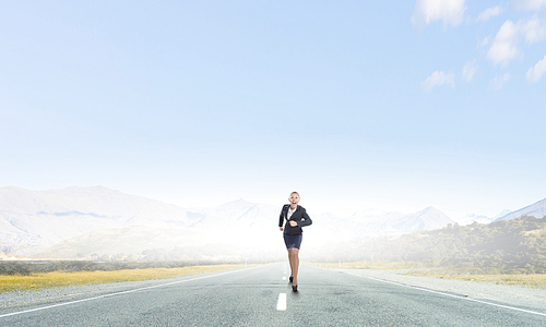 Young determined businesswoman competitor running on road