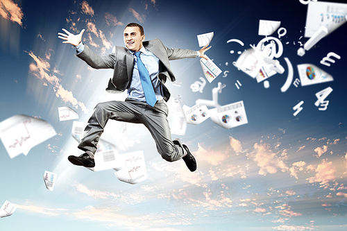 Image of a businessman jumping high against blue sky background