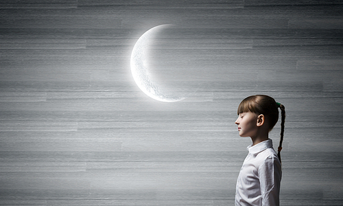 Side view of cute girl and moon above her head