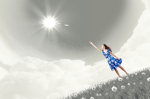 Happy young woman dreaming to fly in sky