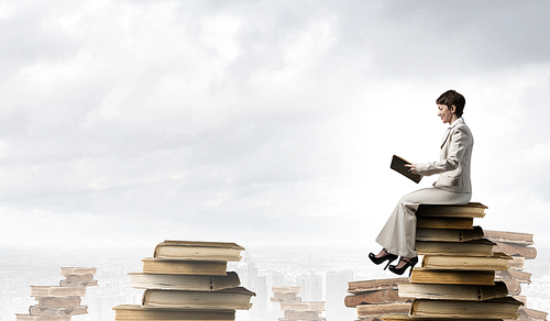 Adult woman in suit with old book in hand