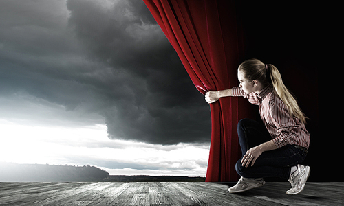 Young woman in casual opening drape curtain