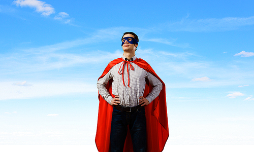 Young man wearing superman mask and cape