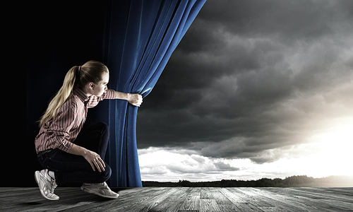 Young woman in casual opening drape curtain