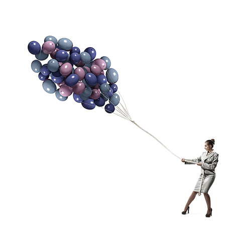 Young businesswoman pulling bunch of colorful balloons