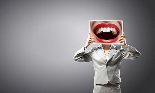 Unrecognizable businesswoman holding big photo with lips