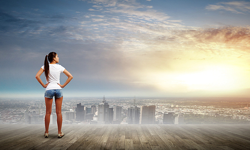 Rear view of young girl in denim shorts