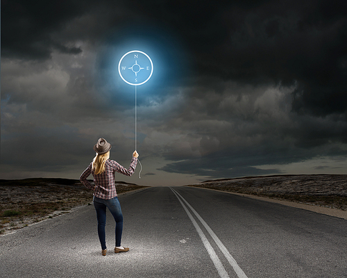 Rear view of woman in casual holding balloon in hand