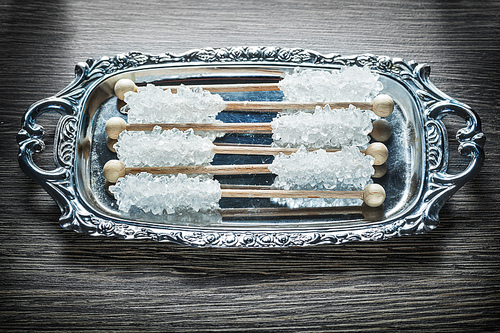 Sweet sugar sticks on metallic tray.