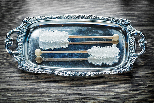 Sugar sticks on metallic tray top view.