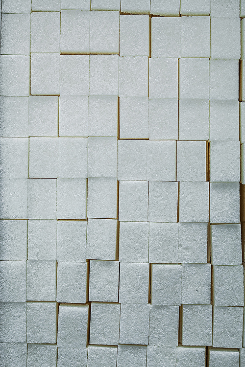 Stack of white sugar cubes food concept.