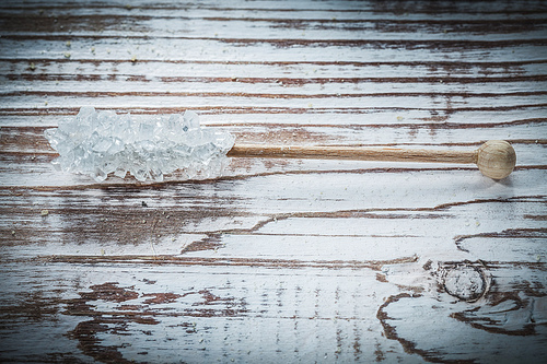 Tasty sugar stick on vintage wooden board.