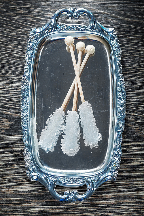 Sugar sticks tray on wooden board.