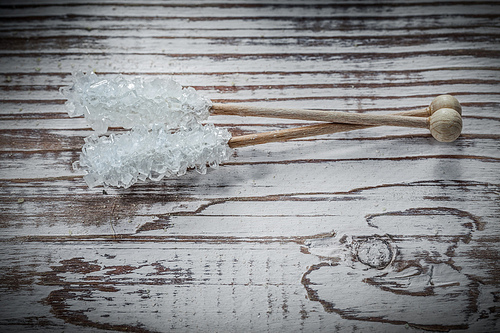 Sugar sticks on vintage wooden board.