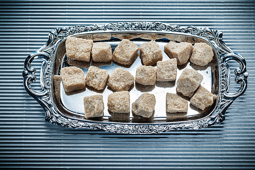 Brown sugar tray on striped background.