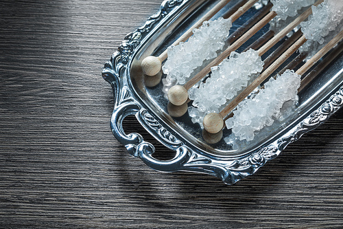 Tasty sugar sticks on metallic tray.