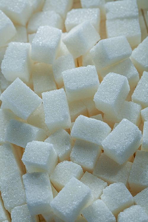 White sugar cubes food concept vertical view.