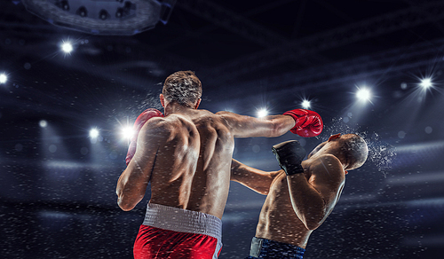 Two professional boxers fighting on arena in spotlights mixed media