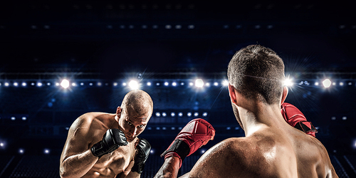 Two professional boxers fighting on arena in spotlights mixed media