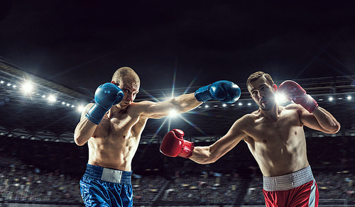 Two professional boxers fighting on arena in spotlights mixed media