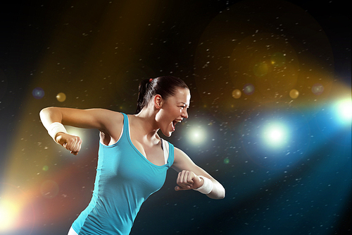 Image of sportswoman exercising against lights background