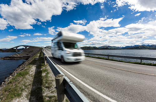 Caravan car RV travels on the highway. Caravan Car in motion blur. Norway. Atlantic Ocean Road or the Atlantic Road (Atlanterhavsveien) been awarded the title as Norwegian Construction of the Century.