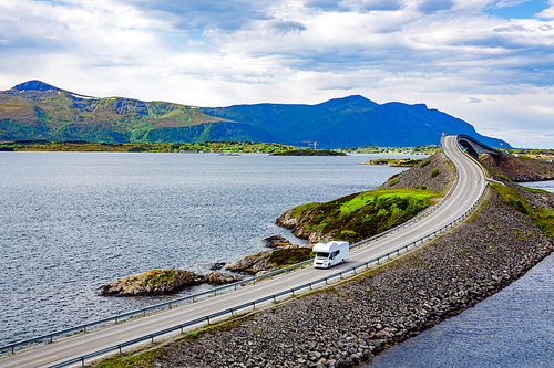 Caravan car RV travels on the highway Norway. Atlantic Ocean Road or the Atlantic Road (Atlanterhavsveien) been awarded the title as (Norwegian Construction of the Century).